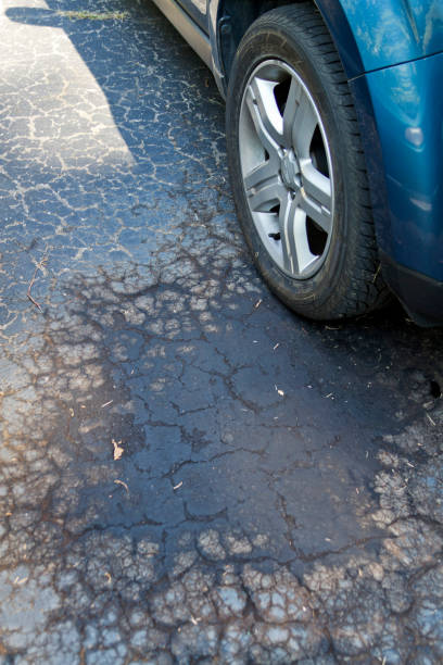 istock Oil Leaking From Under Car Stains Driveway 1368821322
