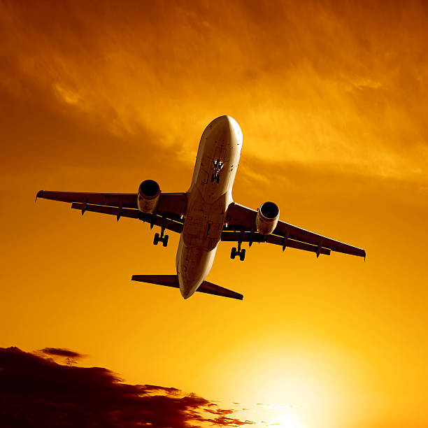 istock XL jet airplane landing at sunset 136882349