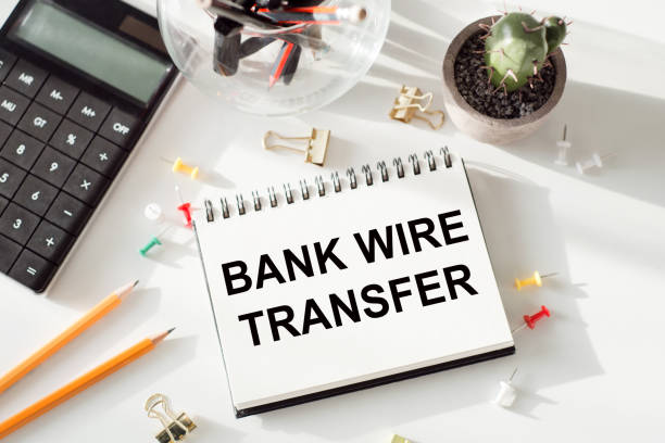 istock Notepad with inscriptions BANK WIRE TRANSFER on a white office background. 1368823547