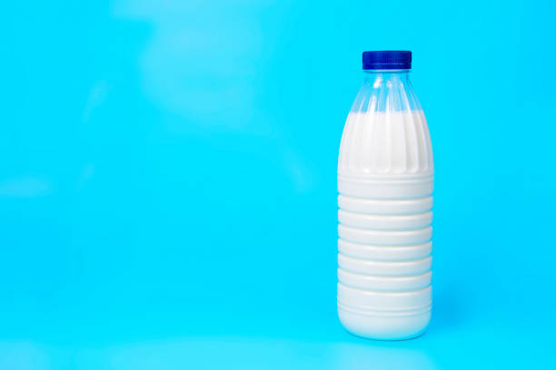 istock Natural fresh milk bottle on blue background with copy space 1368827247