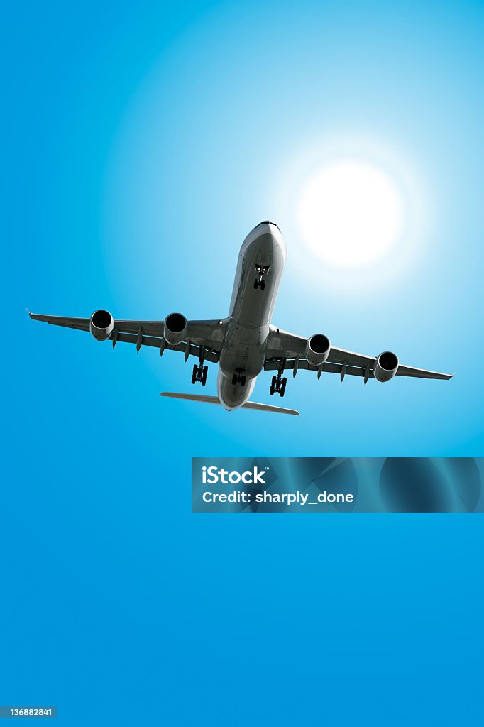 XXL jet airplane landing in sunny sky jet airplane landing in bright sunny sky, vertical frame (XXL) Airplane Stock Photo