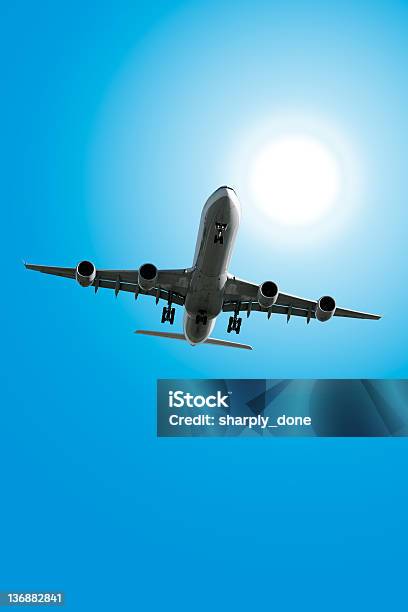 Xxl Jet Airplane Landing In Sunny Sky Stock Photo - Download Image Now - Airplane, Sky, Blue
