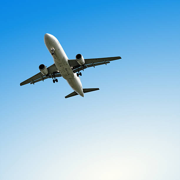 istock jet airplane landing with clear sky 136882872