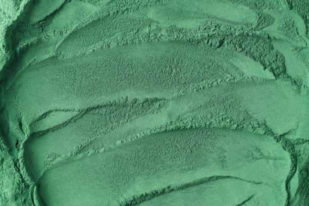istock Green background texture made of spirulina algae powder 1368830444