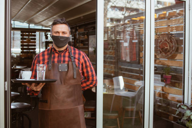 istock A waiter standing in front of a coffee shop 1368830871