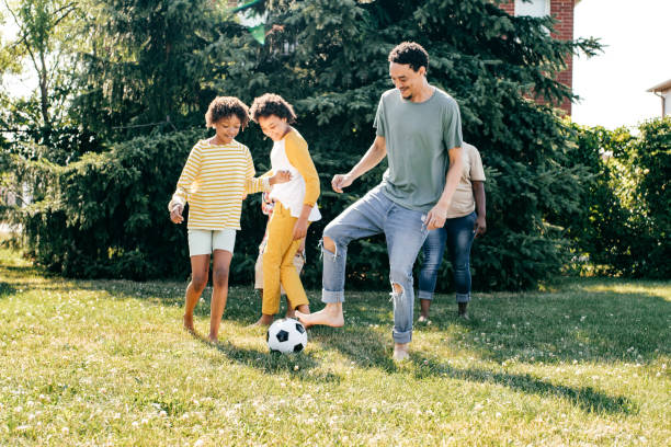 istock Multi-ethnic family playing soccer outdoors 1368832829