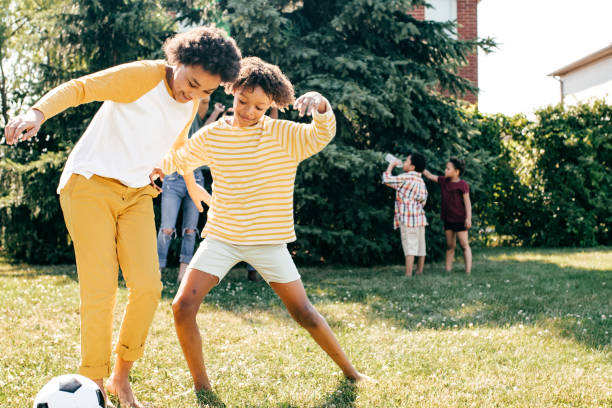 istock Multi-ethnic family playing soccer outdoors 1368832832