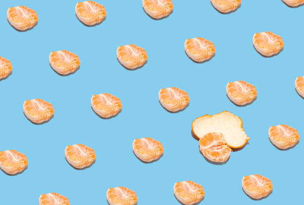istock Fruit pattern of fresh tangerine slices on pastel blue background. Summer creative concept. From top view. 1368833059