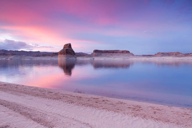 Lone Rock Beach Lake Powell Lone Rock beach at Lake Powell during sunset. lake powell stock pictures, royalty-free photos & images