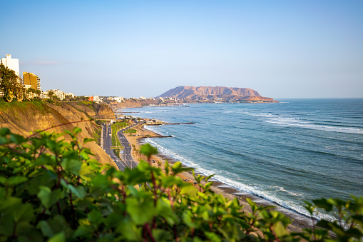 The sun sets over the coast of Lima, Peru in the Miraflores District