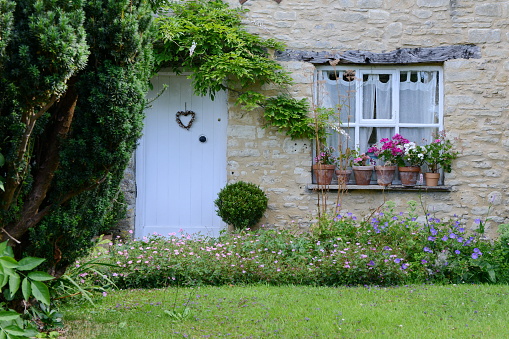 Exterior View of a Traditional Old English Cottage House and Garden
