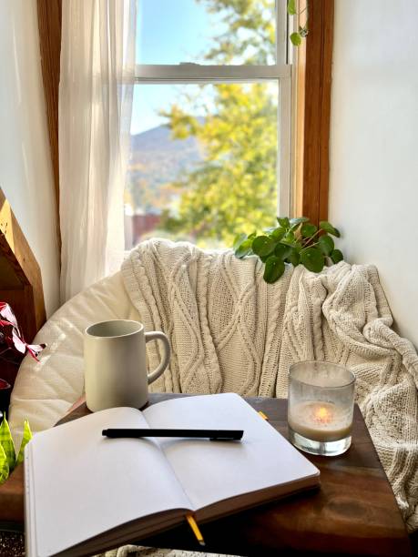 Cozy nook at home to take a break A cozy reading nook with a chair next to a window and a journal to write on. Conveys the ideas of self care and wellness. bullet journal photos stock pictures, royalty-free photos & images