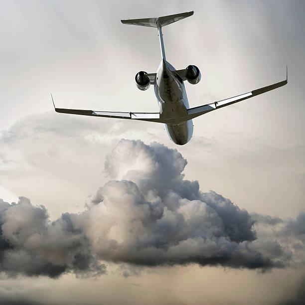 istock corporate jet airplane flying in storm 136883828