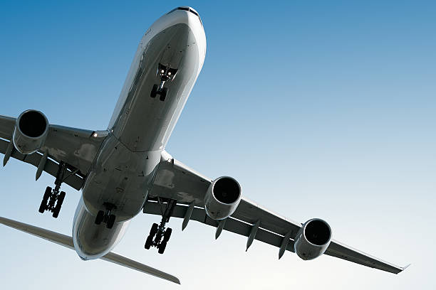 istock jet airplane landing in clear blue sky 136883943