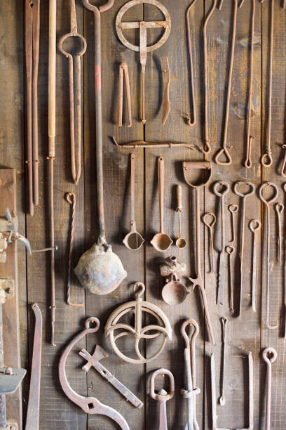 istock Blacksmith Shop Wall of Rusted Tongs and Tools 1368841295