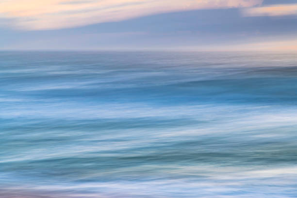 Soft panning Sunrise Seascape with good size waves at MacMasters Beach on the Central Coast, NSW, Australia.