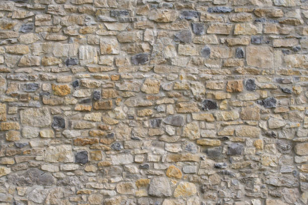 istock Stacked stonewall. Ancient castle or fortress wall made of stone blocks 1368843421