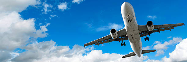 istock jet airplane landing in cloudy sky 136884391