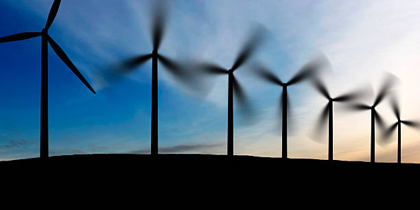 wind farm at dusk wind farm in silhouette at dusk, panoramic frame landscape alternative energy scenics farm stock pictures, royalty-free photos & images