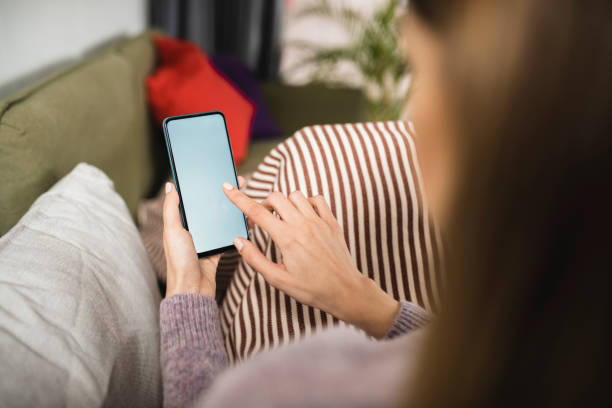 istock Young woman using a smartphone at home 1368844110