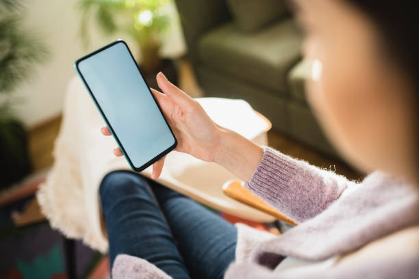 istock Young woman using a smartphone at home 1368844118