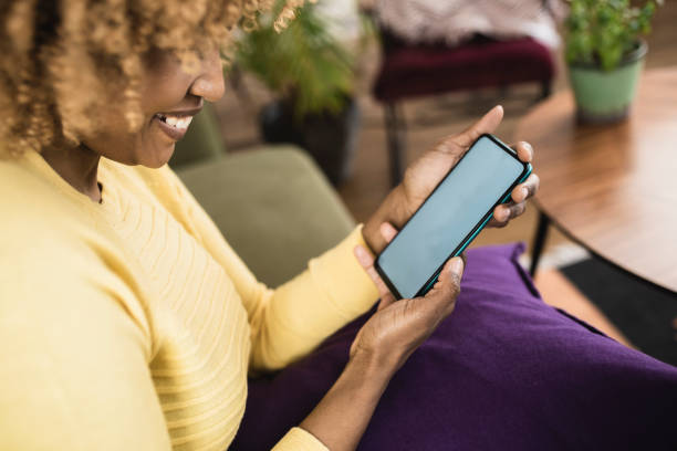 istock Woman using smartphone at home 1368844125