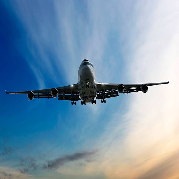 istock jumbo jet airplane landing at dusk 136884522