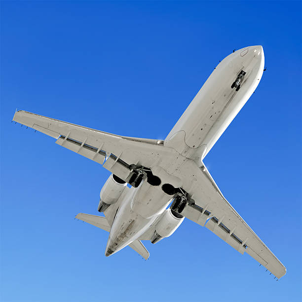 istock corporate jet airplane landing in clear blue sky 136884523