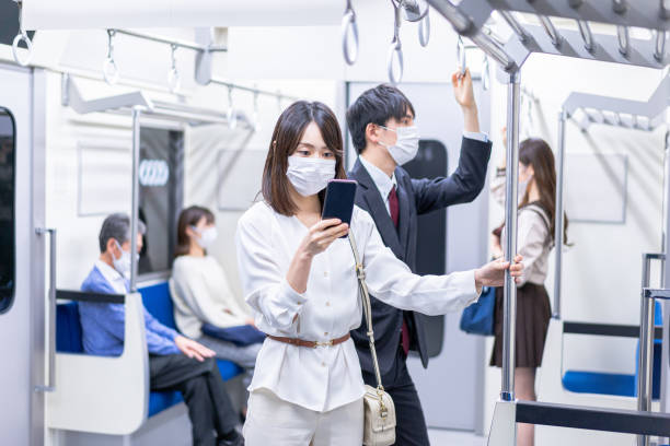istock A young woman wearing a mask while traveling on a train 1368845608