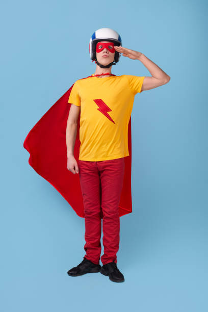 istock Man in superhero costume with saluting gesture 1368847844