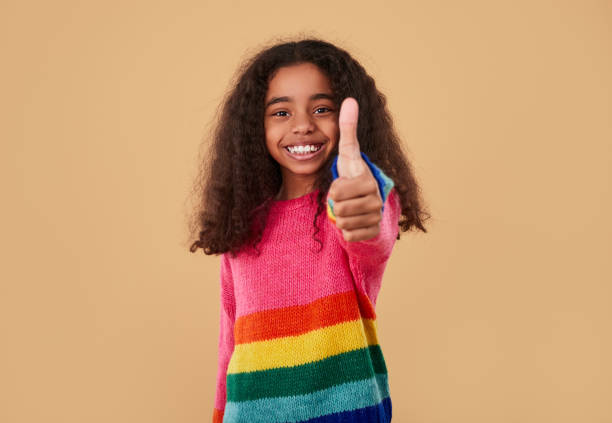 istock Cheerful girl showing thumb up 1368847874