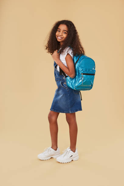 istock Black schoolgirl with trendy backpack 1368847898