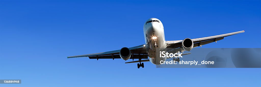 Avião a jato no céu azul límpido pousando - Foto de stock de Avião comercial royalty-free