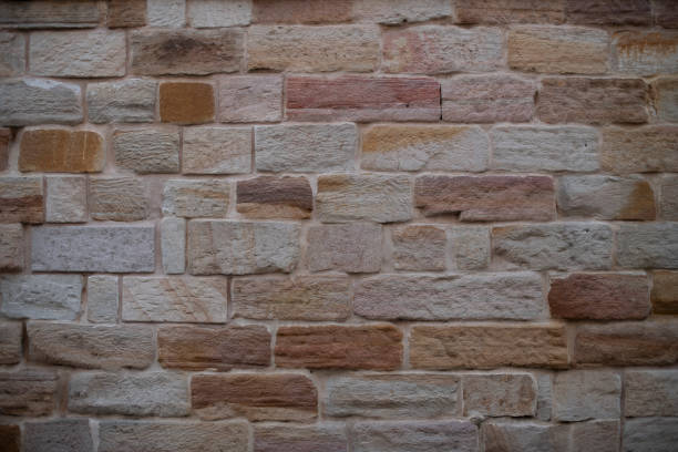 istock Multi-toned brick wall background. Tones are pink, brown, tan and cream. 1368849657