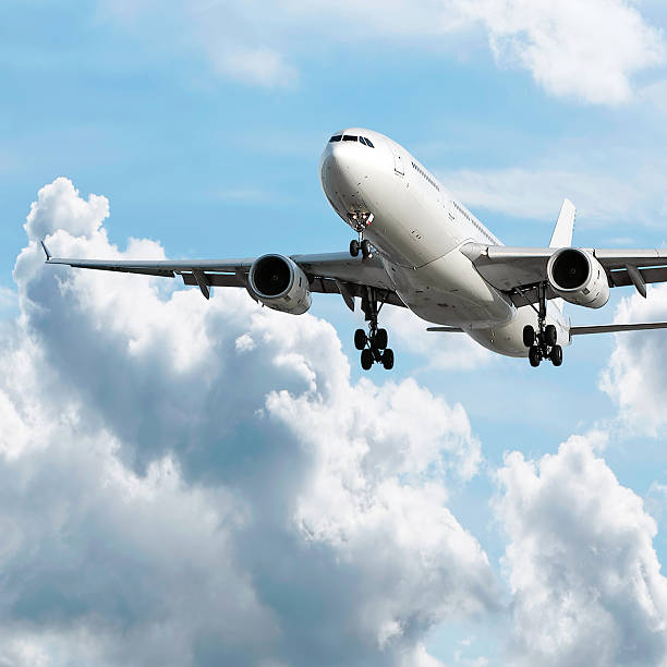 jet airplane landing in bright sky