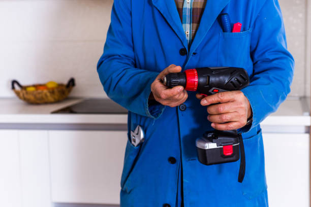 istock Old craftsman holding power drill in kitchen 1368851760