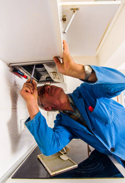 istock Repairman working in the kitchen 1368851812