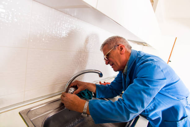 istock Mature laborer fixing the kitchen faucet 1368851834
