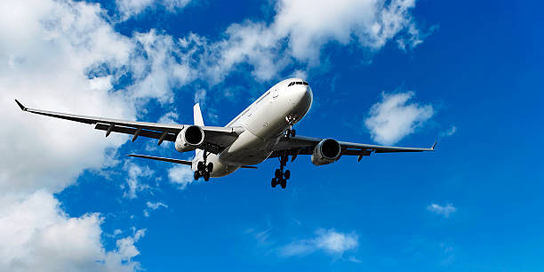 istock jet airplane landing in cloudy sky 136886265