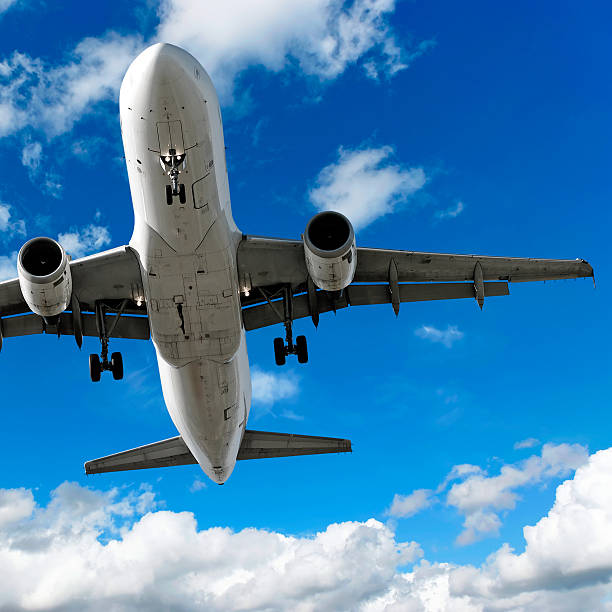 istock jet airplane landing in cloudy sky 136886287