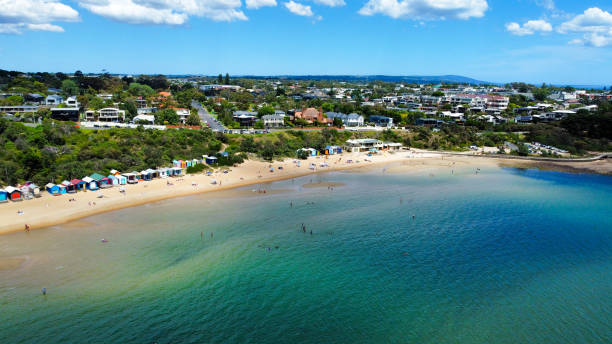 Mornington - Beach Boxes at Mills Beach Mornington peninsula - Aerial Drone view The bathing or beach boxes at mills beach in Mornington on the beautiful Mornington peninsula coast. Stunning Australian coastline in Victoria. Aerial Drone photograph shot with a dji mini2. People swimming and enjoying the beach in Summer. Calm water. mornington peninsula photos stock pictures, royalty-free photos & images
