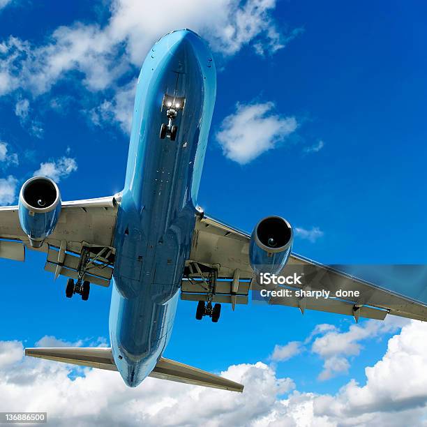 Jet Airplane Landing In Cloudy Sky Stock Photo - Download Image Now - Above, Aerospace Industry, Air Vehicle