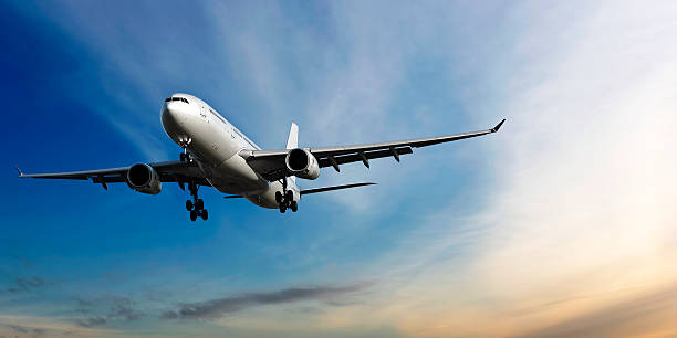 istock XL jet airplane landing at dusk 136886565