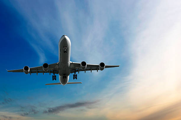 istock XL jet airplane landing at dusk 136886697