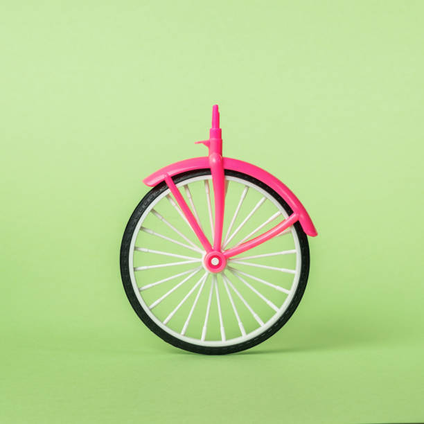 istock A bicycle wheel with a front part on a light green background. 1368870158