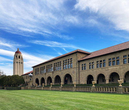 Hoover tower and Lane History Corner building on beautiful campus of Stanford University under blue sky - Palo Alto, California, USA - 2022