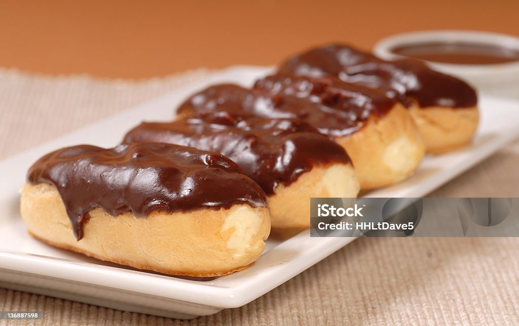 Delicious chocolate eclairs Delicious homemade eclairs with a chocolate ganache and dipping sauce Baked Stock Photo
