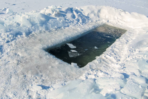 Ice hole in a frozen pond Ice hole for swimming in a frozen pond tambov russia stock pictures, royalty-free photos & images