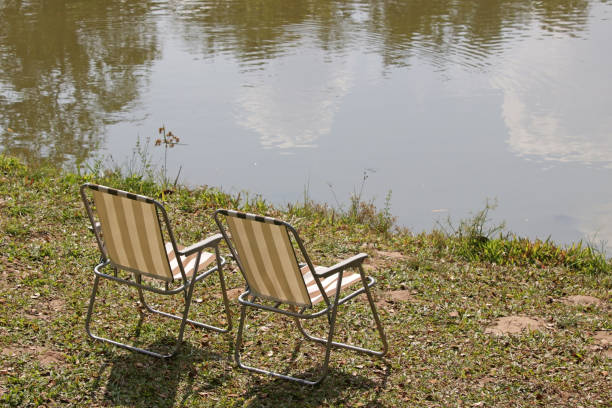 istock Two garden armchairs by a lake 1368880605