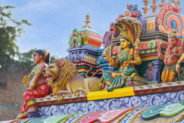 Indian traditional Goddess Mariyamman statue on temple tower stock photo